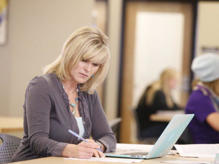 Adult female scholar working on laptop