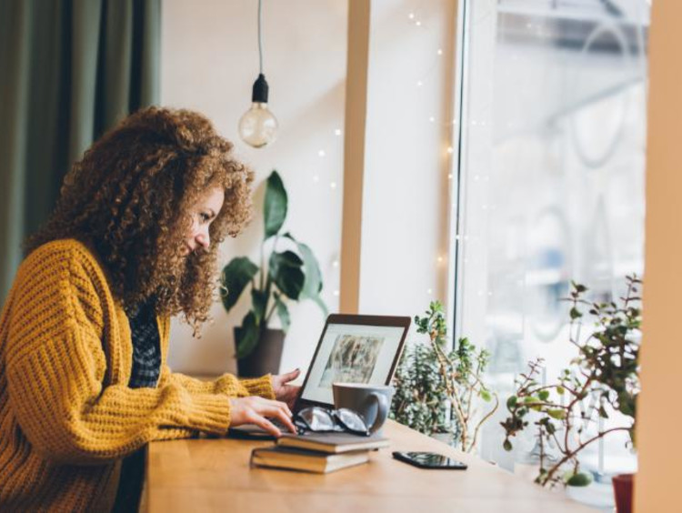 girl working on a laptop in a coffee shop