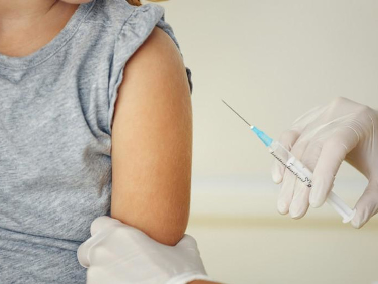 person getting a shot from the doctor.