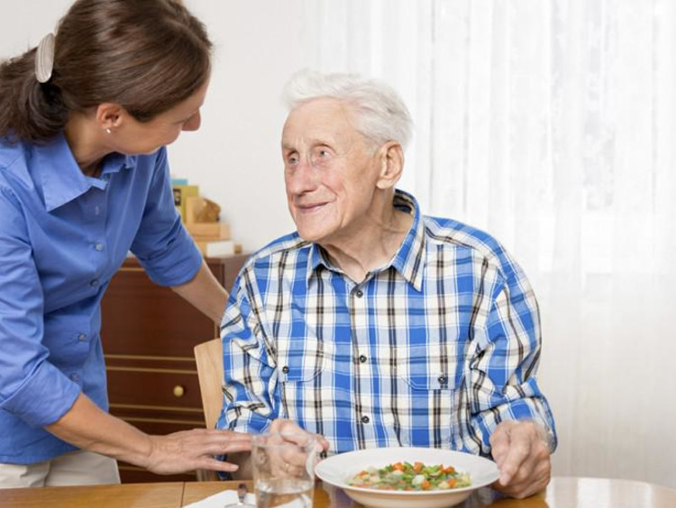 Young adult helps elderly man