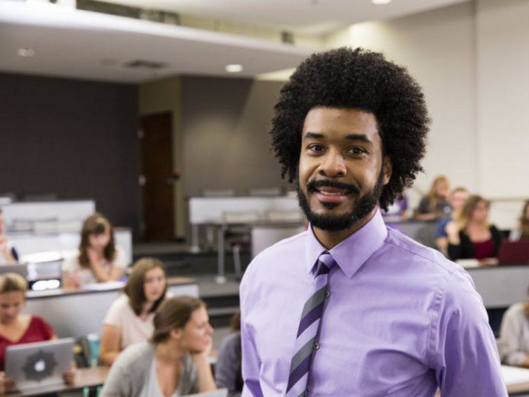 Organizational leadership professor stands in front of class