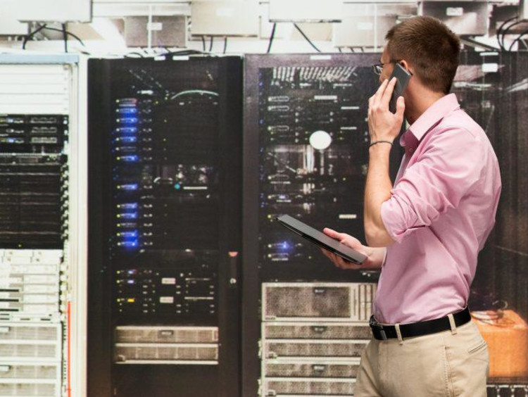 person on phone looking at panel