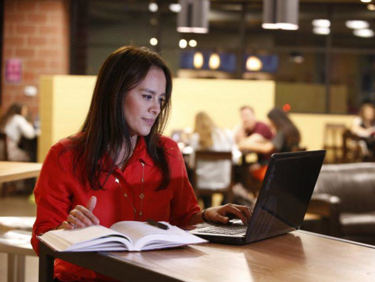 Student reviews MSL course requirements in busy cafe