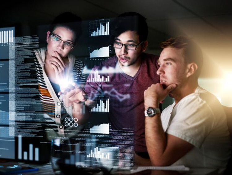 three people looking at a computer