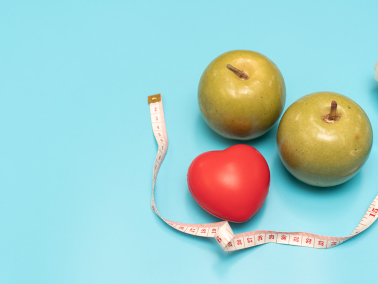 two apples with a heart and measuring tape