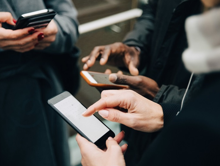 Teenagers interacting with phones