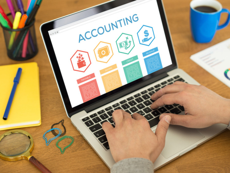 Accountant works on his laptop creating a presentation
