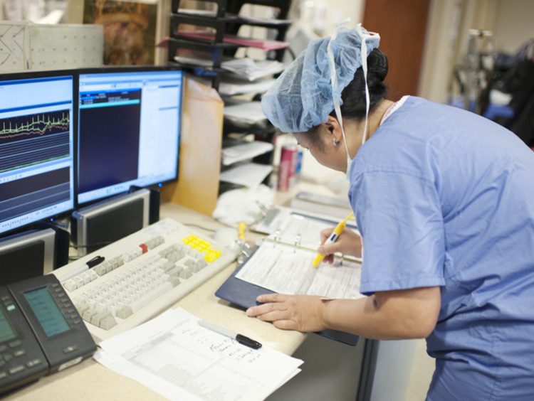 Nurse with an advanced nursing degree working on paperwork