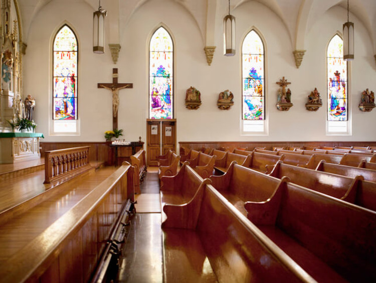 Pews and stained glass windows in church