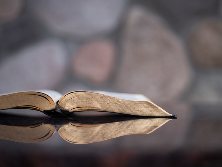 Bible sitting open on a desk