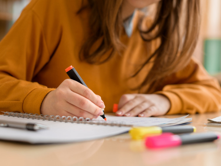 Student writing notes