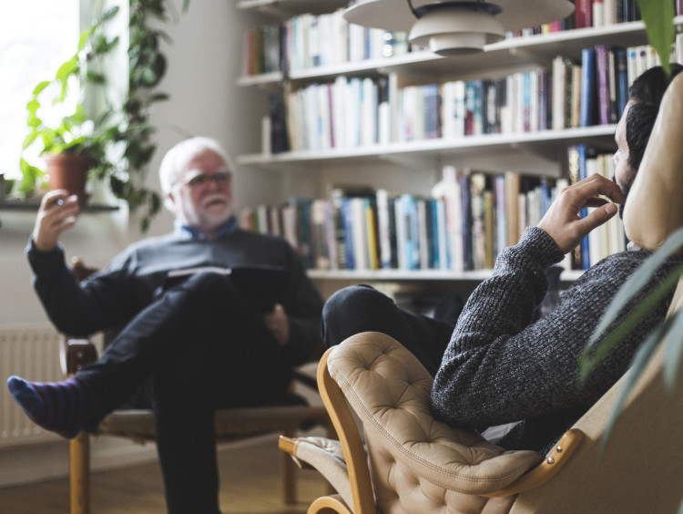 psychologist in chair talking to patient