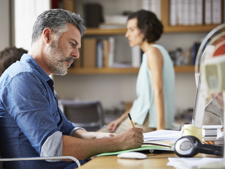 Businessman sitting at desk in an open office