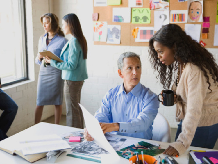 Students earning master's degrees collaborating
