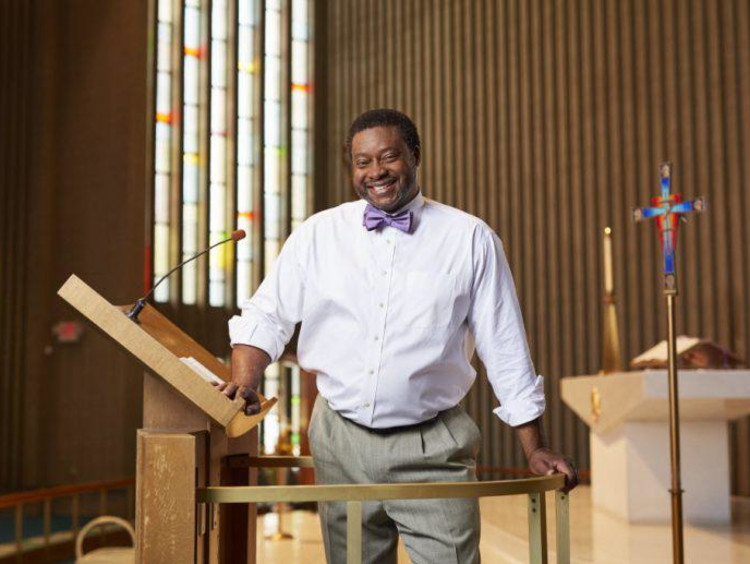 A pastor standing at the front of his church