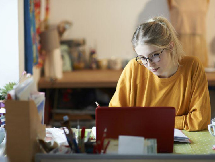 Female student at home studying.