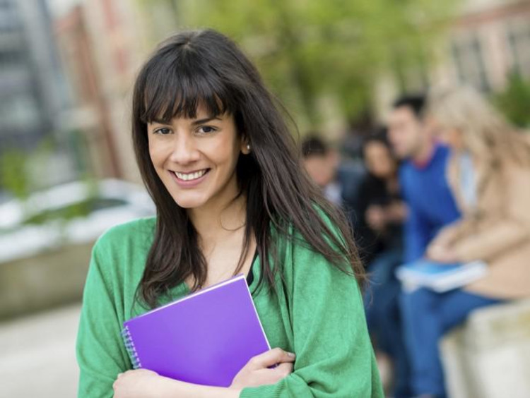 girl holding notebook while walking