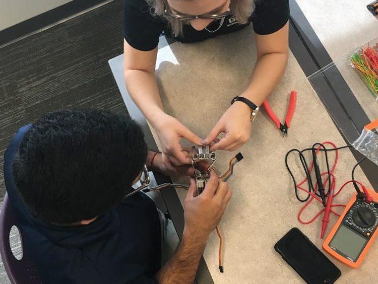 GCU students building a robotic hand