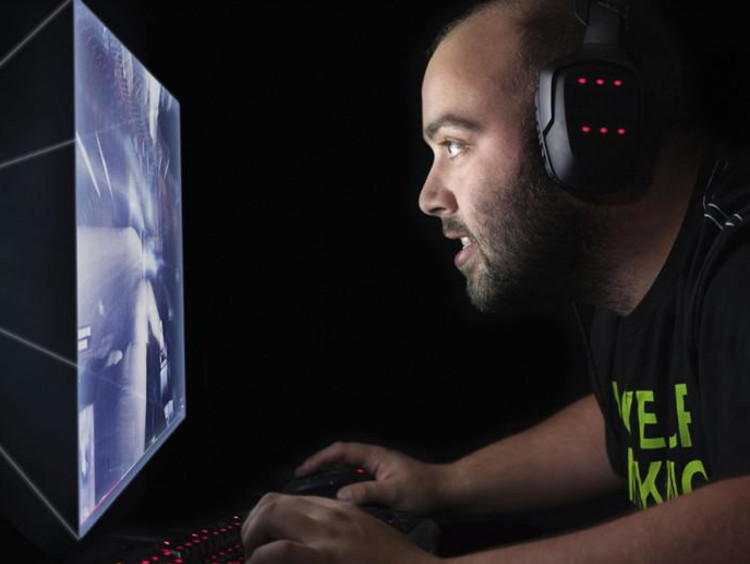 person wearing headphones and looking at a computer