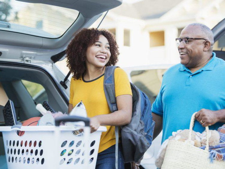 girl and father packing a car