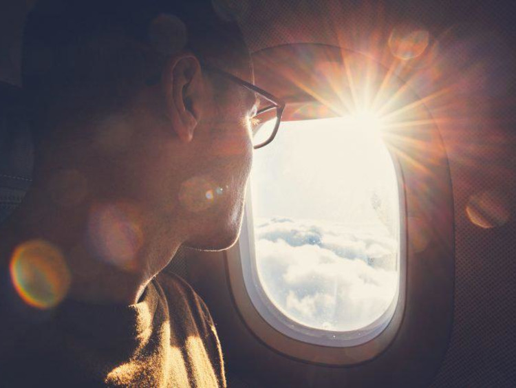 Man looking out of a plane window