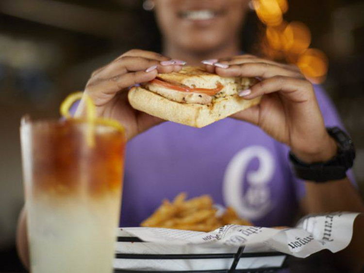 A student eating a sandwich at Canyon 49