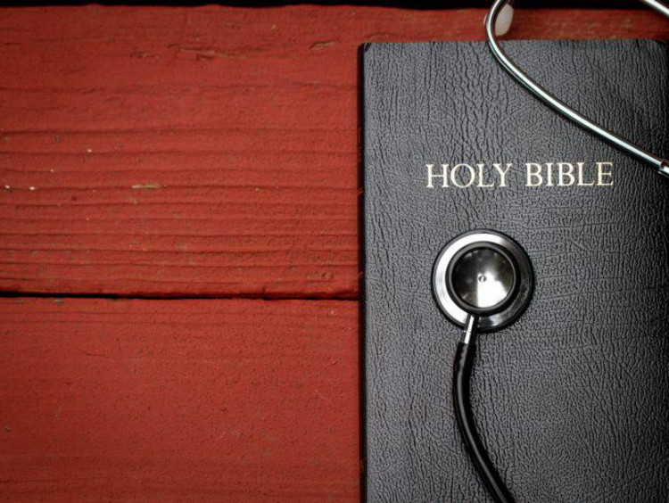 Bible with a stethoscope on top