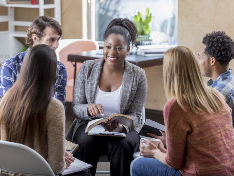 woman leading a book study in a classroom