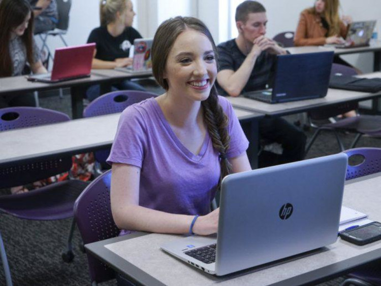 girl typing on a laptop