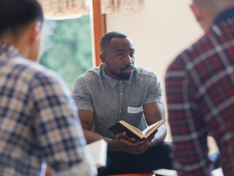 Alex listens during a men's Bible study