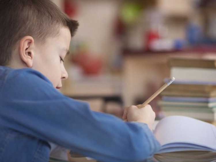 kid writing in notebook