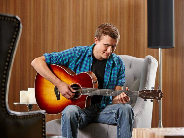 A student playing a guitar