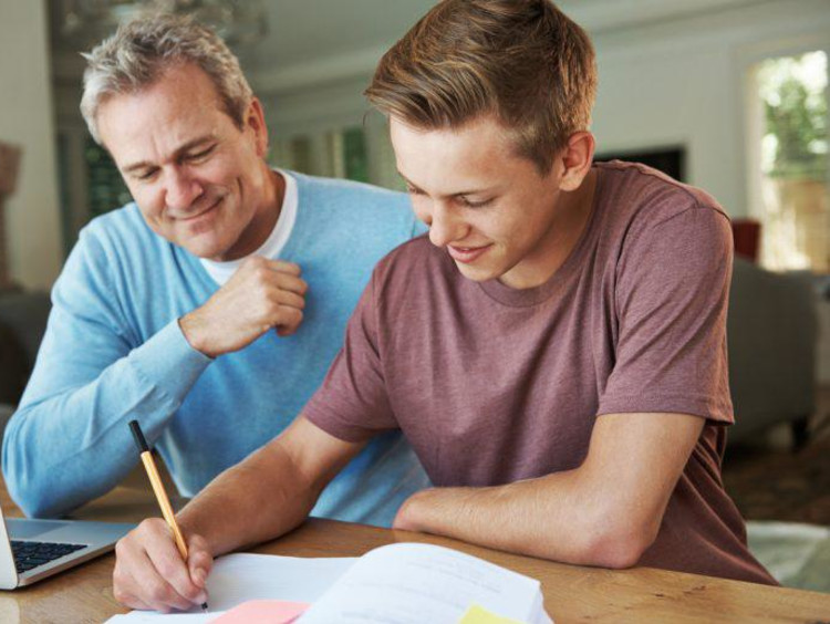 father homeschooling son
