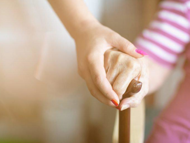 Woman holding a child's hand