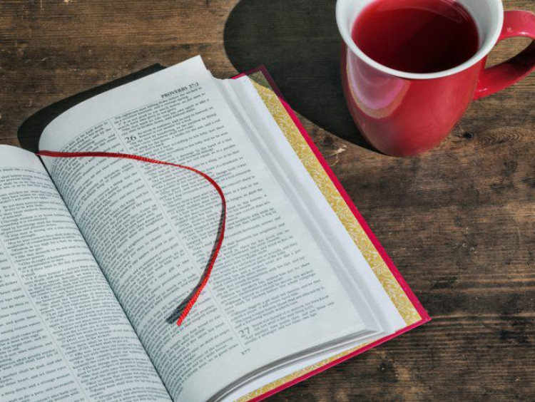 A Bible open on a coffee table