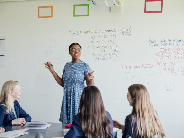 Math teacher working with eager high school students