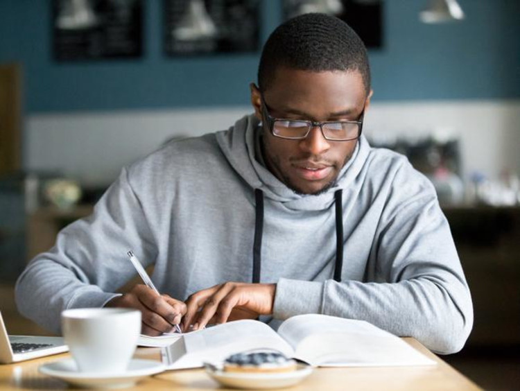 Doctoral student working on a paper