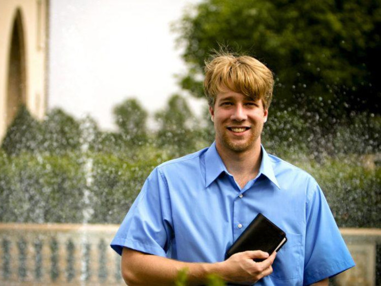 A seminary student holding the Bible outside