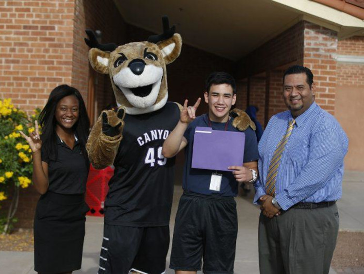 thunder and gcu students holding a lopes up
