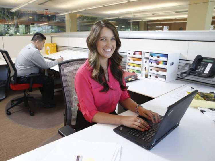 young woman working at her desk in an office