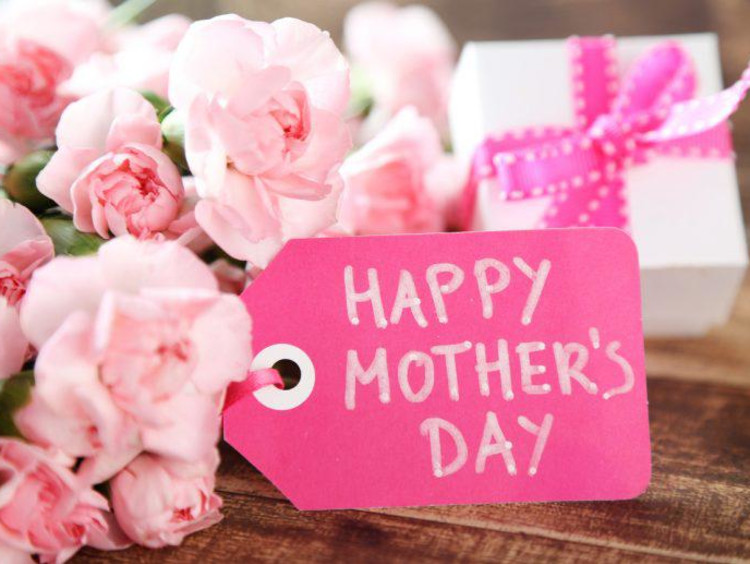 Hot pink Happy Mother's Day tag with lighter pink flowers and gift in background