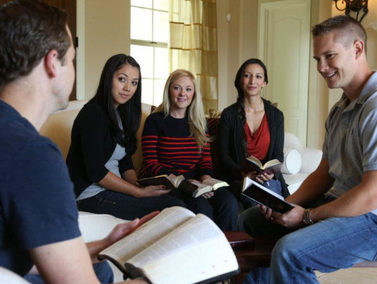 A group of students studying the Bible