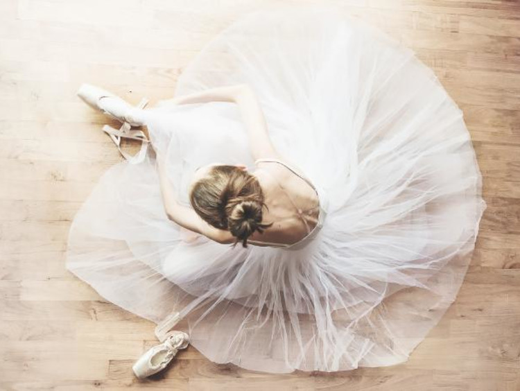 Ballerina putting on shoes