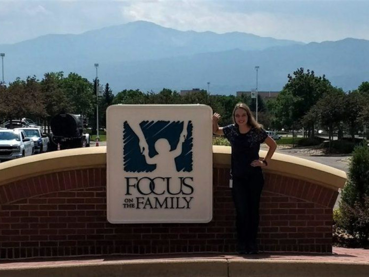 Rachel in front of a FOCUS sign