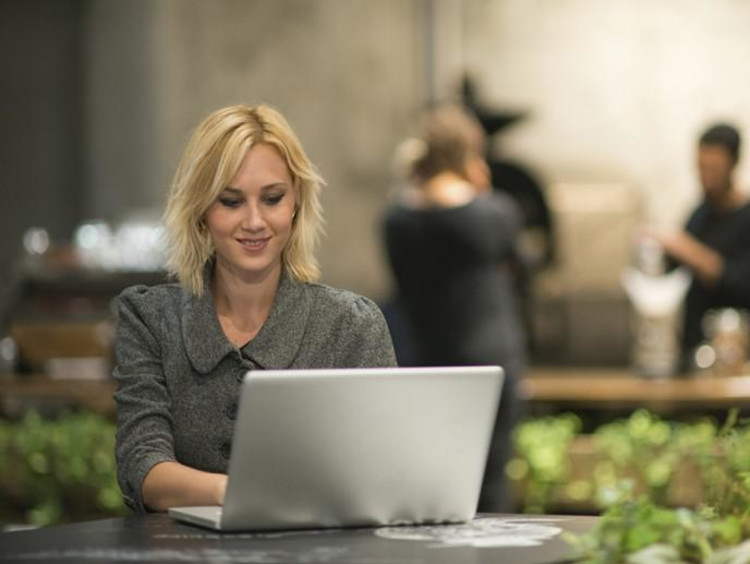 Blonde professional woman typing on her computer