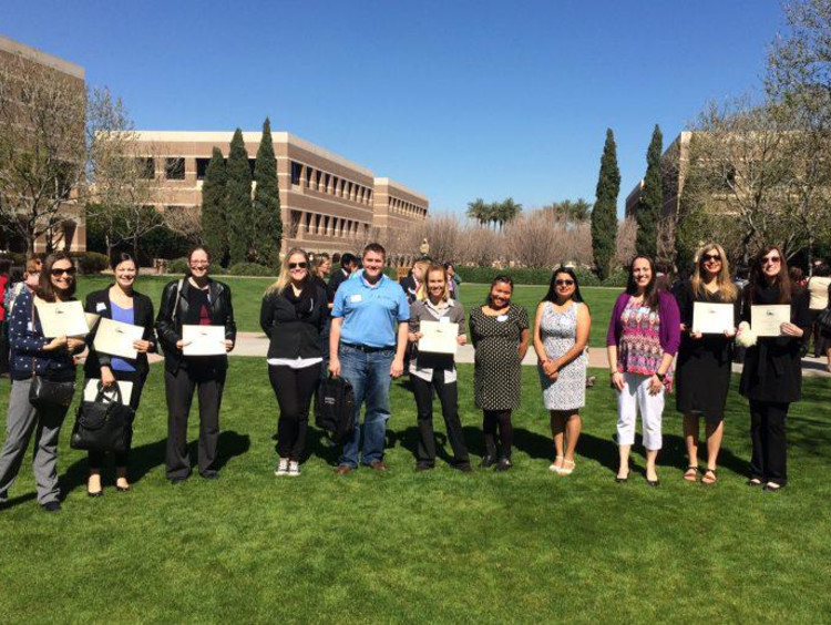 people holding certificates and smiling