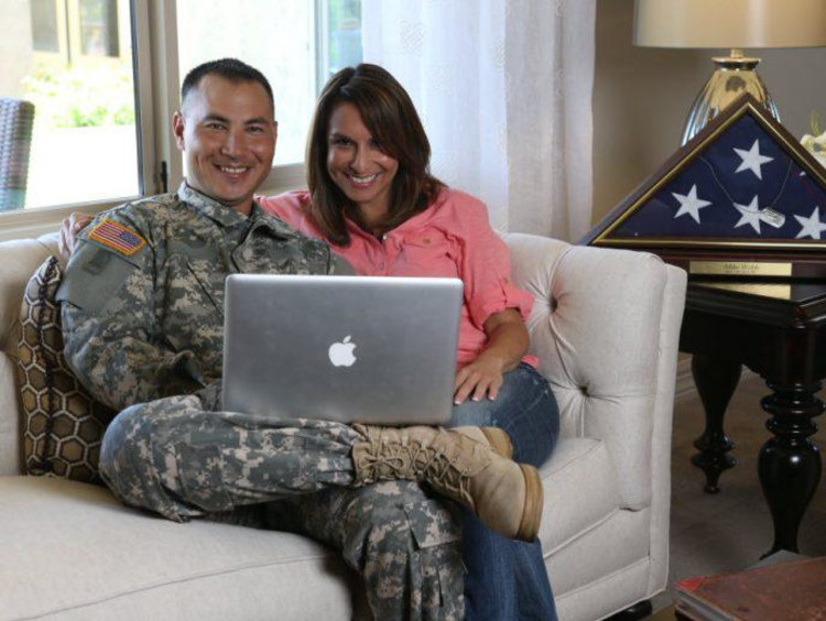 A veteran sitting with his partner in their home
