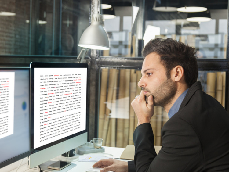 copy editor working in office reading online