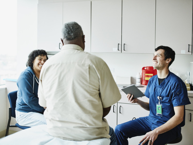 APRN talking with a patient in office