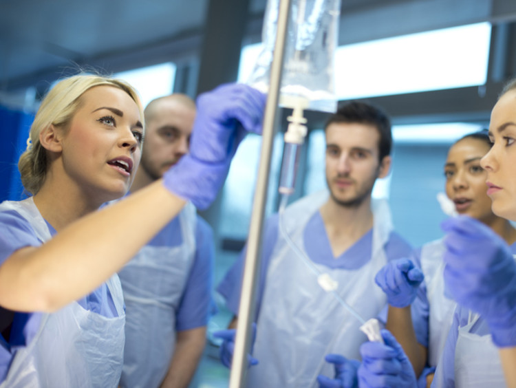 A group of nursing students learning to do an IV drip